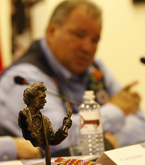 With the bronge image of Louis Riel in the foreground Manitoba Metis Federation president David Chartrand introduces his  Land Claims Strategic Investment Committee  -they include  David Chartrand Pres. Of MMF , with former PM , Paul Martin , Hartley Richardson , Sanford  Riley , Harvey Secter , Dr. Eric   Newell . KEN GIGLIOTTI / JULY 31 2013 / WINNIPEG FREE PRESS
