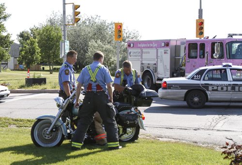 A crash involving a motorcycle and a passenger vehicle occurred on Pembina at the Perimeter Hwy this morning before 9 a.m. According to personnel at the scene, the motorcycle skidded into the back of the vehicle which was stopped in the southbound lane at the traffic lights. The motorcyclist was transported to hospital with a possible broken leg. The occupants of the vehicle were unharmed. Wednesday, July 31, 2013. (JESSICA BURTNICK/WINNIPEG FREE PRESS)
