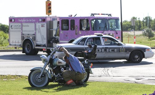 A crash involving a motorcycle and a passenger vehicle occurred on Pembina at the Perimeter Hwy this morning before 9 a.m. According to personnel at the scene, the motorcycle skidded into the back of the vehicle which was stopped in the southbound lane at the traffic lights. The motorcyclist was transported to hospital with a possible broken leg. The occupants of the vehicle were unharmed. Wednesday, July 31, 2013. (JESSICA BURTNICK/WINNIPEG FREE PRESS)