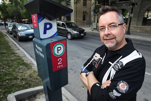 John Giavedoni with the Residents of the Exchange District Group stands by a parking meter on Bannatyne in the East Exchange area. He is upset that the city is scrapping the parking permit program for area residents. 130731 - July 31, 2013 Mike Deal / Winnipeg Free Press