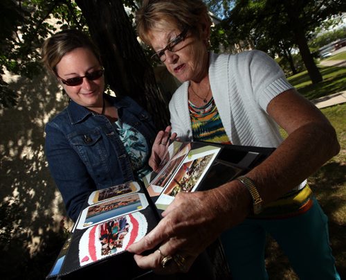 adine Konyk and her mother Jocelyne hold and look through her father's "memorial scrapbook".  Story about family of deceased former Winnipeg firefighter who accidentally lost his memorial scrapbook and moms grief journal (it fell out of the trunk of their car when they were gathering for the anniversary of his death in 2012. He died of  cancer in 2011) about 15 months ago. The other day, a little old lady walked into a fire station at McGregor and Redwood and dropped both items off in a bag. Nobody got her name and they dont know how she came by the album and journal. Fire Station captain, Brent Cheater, recognized the firefighter (Dave Konyk) and managed to track down family. Mother Jocelyne now lives in Quebec, but just happened to be in town helping daughter Nadine move to Alberta this week. August 2, 2013 - (Phil Hossack / Winnipeg Free Press)