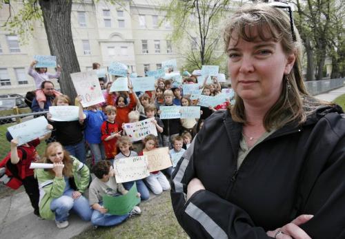 John Woods / Winnipeg Free Press / May 11/07- 070511  - Backed up by students and parents from Ecole Provencher Alison Weir is leading the charge against the Louis Riel school division's plans to change the school's curriculum from a 50/50 program to a 100% french immersion program.   Photographed outside Ecole Provencher Friday, May 11/07.