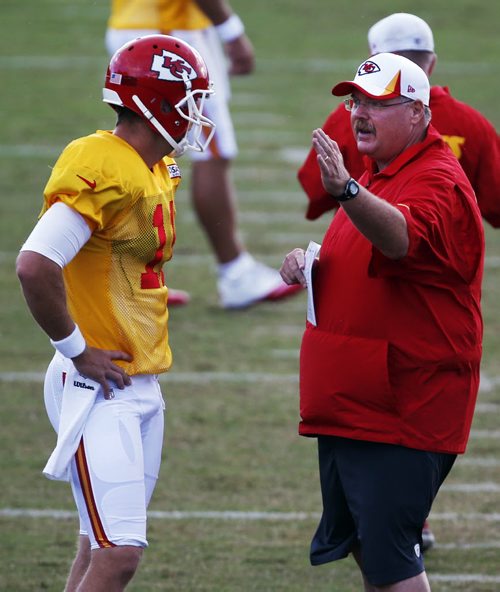 Kansas City Chiefs coach Andy Reid, right, talks with quarterback Alex Smith (11) during NFL football training camp in St. Joseph, Mo., Friday, Aug. 2, 2013. (AP Photo/Orlin Wagner)