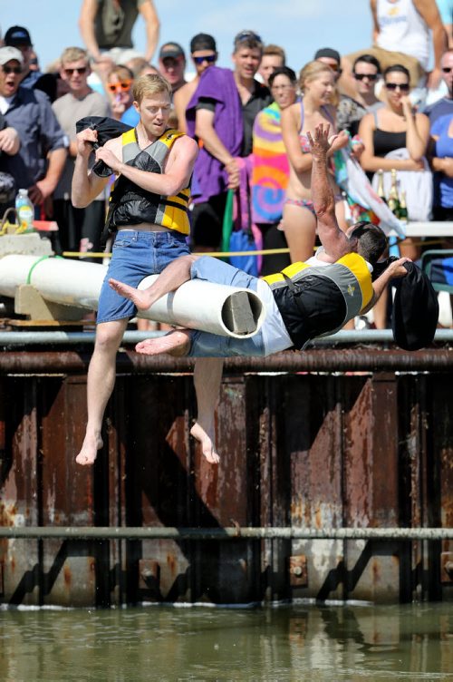 Paul May "The Albino Rhino" defeats Greg "Scrawny Kid" Jordan to win his 4th consecutive title. Competitors battle one another with a sponge filled sack, while sitting on a soap covered beam over Gimli Harbour during the Islendingadunk competition at the Icelandic Festival of Manitoba in Gimli, Saturday, August 3, 2013. (TREVOR HAGAN/WINNIPEG FREE PRESS)