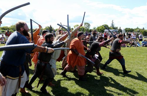 Members of Vikings Vinland, a group made up of members from across Canada, the US and Europe, charge into battle wielding pool noodles as they fight against a group of children at the Icelandic Festival of Manitoba in Gimli, Saturday, August 3, 2013. (TREVOR HAGAN/WINNIPEG FREE PRESS)