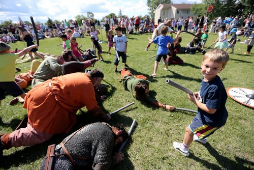 Daniel Stipanovic, 5, smiles after defeating several members of Vikings Vinland, a group made up of members from across Canada, the US and Europe, in a pool noodle battle at the Icelandic Festival of Manitoba in Gimli, Saturday, August 3, 2013. (TREVOR HAGAN/WINNIPEG FREE PRESS)