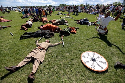 Members of Vikings Vinland, a group made up of members from across Canada, the US and Europe, laying on the battlefield following a demontration at the Icelandic Festival of Manitoba in Gimli, Saturday, August 3, 2013. (TREVOR HAGAN/WINNIPEG FREE PRESS)