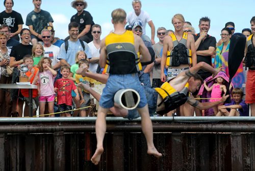Spectators look on as competitors battle one another with a sponge filled sack, while sitting on a soap covered beam over Gimli Harbour during the Islendingadunk competition at the Icelandic Festival of Manitoba in Gimli, Saturday, August 3, 2013. (TREVOR HAGAN/WINNIPEG FREE PRESS)
