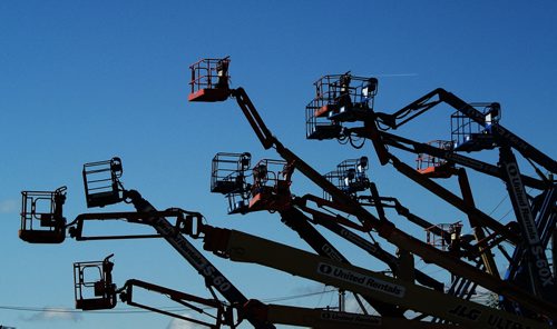 As though they were robotic flowers reaching for the sun, boom lifts sit idle at United Rentals on Route 90 Monday morning.  130805 August 05, 2013 Mike Deal / Winnipeg Free Press