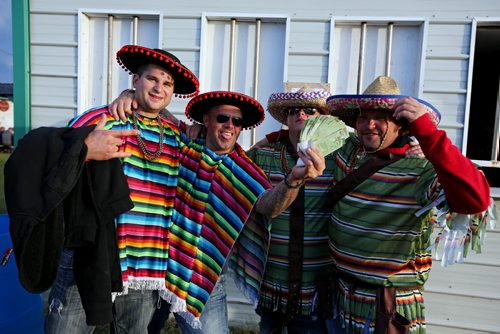 Brandon Sun 08042013 Four amigos joke around during Rockin' the fields of Minnedosa on Sunday. (Tim Smith/Brandon Sun)