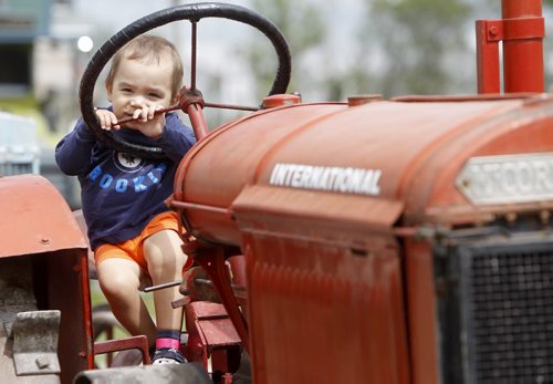 Dylan Rempel, 2, on a tractor at the Steinbach Pioneer Days at the Steinbach Mennonite Heritage Village, Sunday, August 4, 2013. (TREVOR HAGAN/WINNIPEG FREE PRESS)