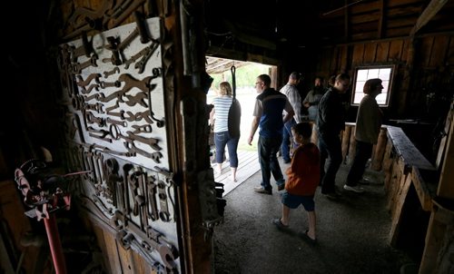 Visitors in the blacksmith shop during the Steinbach Pioneer Days at the Steinbach Mennonite Heritage Village, Sunday, August 4, 2013. (TREVOR HAGAN/WINNIPEG FREE PRESS)