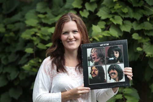 Stacey Nattrass holding up a copy of Let it Be. For Dave Sanderson story  timed for the McCartney show; asked prominent Winnipeggers what their fave McCartney or Beatles track is all-time.   Wayne Glowacki / Winnipeg Free Press Aug. 6  2013