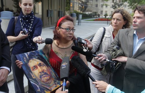 COURTS -Inquest begins today into Brian Sinclair hospital death.  Esther Grant holds a painting by artist Gord Hagman of Brian Sinclair outside of the courthouse.  BORIS MINKEVICH / WINNIPEG FREE PRESS August 6, 2013