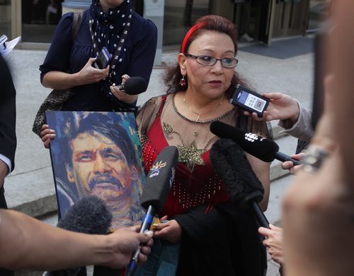 COURTS -Inquest begins today into Brian Sinclair hospital death.  Esther Grant holds a painting by artist Gord Hagman of Brian Sinclair outside of the courthouse.  BORIS MINKEVICH / WINNIPEG FREE PRESS August 6, 2013