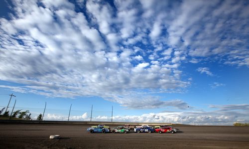 Dirt Track Racing....Day in the Life Shot Aug 1, 2013 .Drivers in start formation move their "Modifieds" towards the green flag to start and evening of racing under a prairie sky. ....Aug 1, 2013 - (Phil Hossack / Winnipeg Free Press)