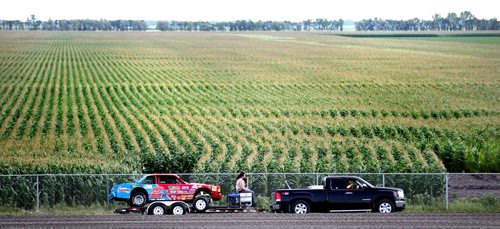 Dirt Track Racing....Day in the Life SHot Aug 1, 2013 Early arrivals enter the pit area framed with a cornfield backdrop backdrop to prepare for race night at Red River Co-op Speedway.....Aug 1, 2013 - (Phil Hossack / Winnipeg Free Press)