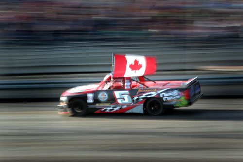 Dirt Track Racing....Day in the Life SHot Aug 1, 2013 Glenn Manning parades the Canadain Flag during the National Anthems opening race night at Red River Co-op Speedway.....Aug 1, 2013 - (Phil Hossack / Winnipeg Free Press)
