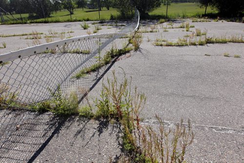 Tennis courts are in need of repair behind Margaret Grant Pool. BORIS MINKEVICH / WINNIPEG FREE PRESS. August 6, 2013