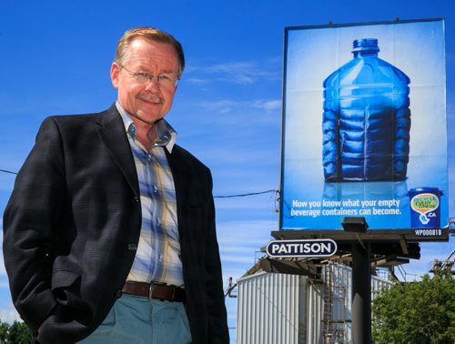 Ken Friesen, Executive Director of the Canadian Beverage Container Recycling Association, near one of many new ads for the Recycle Everywhere campaign that aims to educated people on the transformation of recycled products to new products. (Story by Kitrbyson) 130806 - Tuesday, August 06, 2013 - (Melissa Tait / Winnipeg Free Press)
