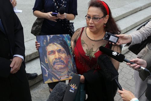Inquest begins today into Brian Sinclair hospital death.  Esther Grant holds a painting by artist Gord Hagman of Brian Sinclair outside of the courthouse.  BORIS MINKEVICH / WINNIPEG FREE PRESS August 6, 2013