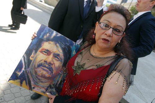 Inquest begins today into Brian Sinclair hospital death.  Esther Grant holds a painting by artist Gord Hagman of Brian Sinclair outside of the courthouse.  BORIS MINKEVICH / WINNIPEG FREE PRESS August 6, 2013