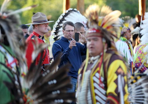 Jets owner Mark Chipman takes a IPhone picture at the Fisher River Cree Nation annual pow wow Tuesday evening- Chipman was among the guests of honour during the grand entry    Standup photo- Aug 06, 2013   (JOE BRYKSA / WINNIPEG FREE PRESS)