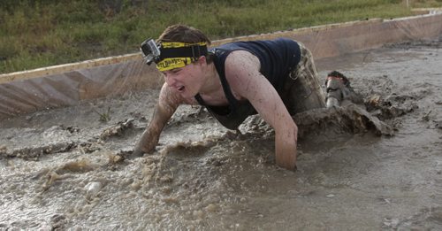 Winnipeg Free Press reporter Oliver Sachgau in the Mud Mayhem obstacle during the Dirty Donkey Mud Run Media event Wednesday morning at Spring Hill Winter Park. Members of the media had a opportunity to try a few of the  obstacles participants in the up coming Dirty Donkey Mud Run on August 17th 2013 in support of the United Way will go through. Wayne Glowacki / Winnipeg Free Press Aug. 7  2013
