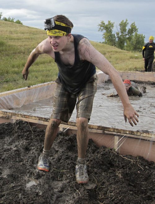 Winnipeg Free Press reporter Oliver Sachgau steps out of the Mud Mayhem obstacle during the Dirty Donkey Mud Run Media event Wednesday morning at Spring Hill Winter Park. Members of the media had a opportunity to try a few of the  obstacles participants in the up coming Dirty Donkey Mud Run on August 17th 2013 in support of the United Way will go through. Wayne Glowacki / Winnipeg Free Press Aug. 7  2013