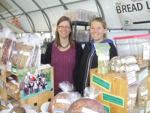 Canstar Community News July 27, 2013 - Natalie Dueck (left) and daughter Dayvia, from New Bothwell, were selling freshly baked breads at their stall in the St. Norbert Farmer's Market. (ANDREA GEARY/CANSTAR COMMUNITY NEWS)