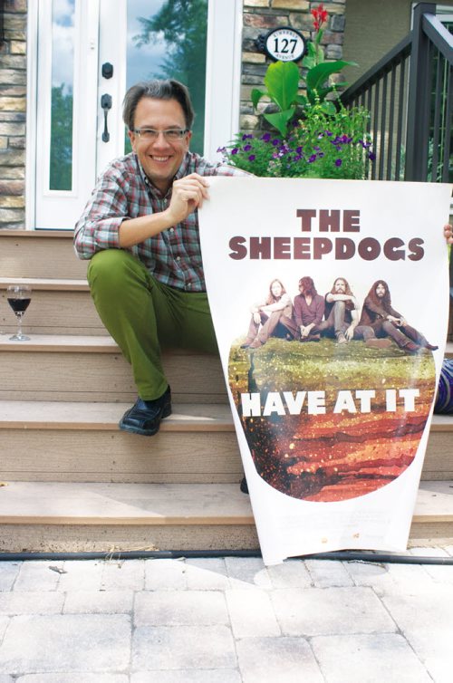 Canstar Community News July 23, 2013 - Director John Barnard shows off the poster for his rock documentary The Sheepdogs Have At It in front of his North Kildonan home. (DAN FALLOON/CANSTAR COMMUNITY NEWS/HERALD)