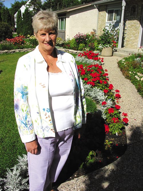 Canstar Community News JULY 31, 2013 -- Val Johnson, a past president and key member of the St. Vital Agricultural Society, in her backyard days before the organization's annual display and fair, which is themed Winter's Wonderland this year.  SIMON FULLER/CANSTAR COMMUNITY NEWS