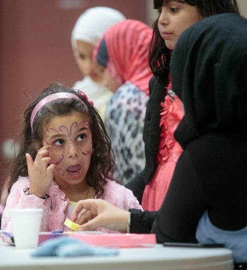 Samia Misbah has her face painted during a potluck celebrating Eid at the Grand Mosque on Waverley Thursday afternoon. The celebration was one of many in Winnipeg to mark the start of Eid and the end of Ramadan, the Islamic holy month of fasting. 130808 - Thursday, August 08, 2013 - (Melissa Tait / Winnipeg Free Press)