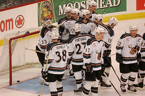 BORIS MINKEVICH / WINNIPEG FREE PRESS  070514 Moose goalie Wayne Flaherty is consoled by team members Lee Goren and Dustin Wood.