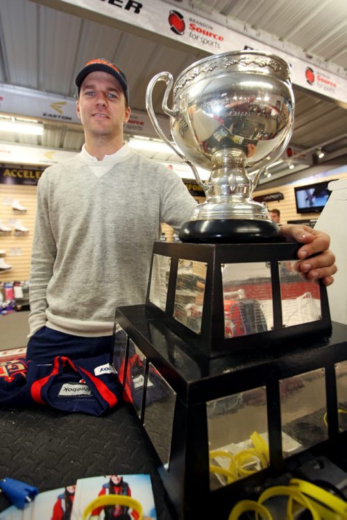 Brandon Sun 09082013 AHL player Brett Skinner displays the American Hockey League championship trophy the Calder Cup that he won with his team the Grand Rapids Griffins while making an appearance at Brandon source for Sports on Friday so hockey fans can get a look at the trophy. (Tim Smith/Brandon Sun)