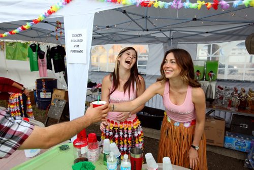 Brandon Sun 09082013 Lacey Tremaine and Brooke Ward laugh while serving drinks during the 1st Annual Margarita-Ville Beach Party at The Dock on Princess on Friday evening. The weekend-long party includes a wing eating contest today at 2PM and a Jimmy Buffet tribute performing throughout the weekend. (Tim Smith/Brandon Sun)