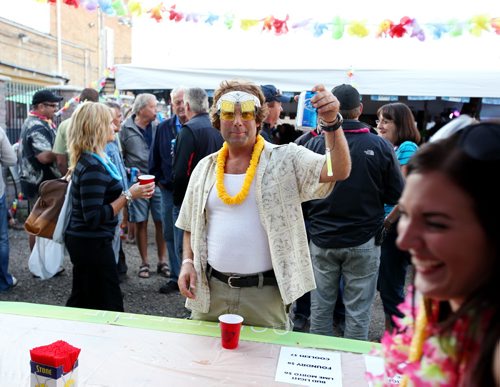 Brandon Sun 09082013 A visitor to the 1st Annual Margarita-Ville Beach Party at The Dock on Princess orders drinks on Friday evening. The weekend-long party includes a wing eating contest today at 2PM and a Jimmy Buffet tribute performing throughout the weekend. (Tim Smith/Brandon Sun)