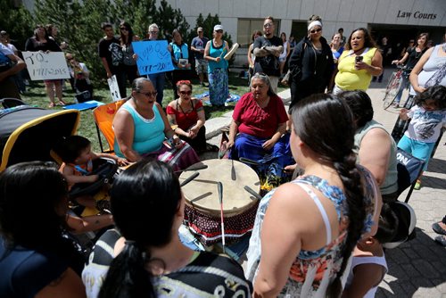 A group that gathered across from the Remand Centre performing a tribute song, during National Prisoner Justice Day, Saturday, August 10, 2013. (TREVOR HAGAN/WINNIPEG FREE PRESS)