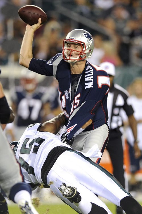 New England Patriots quarterback Ryan Mallett tries to pass the ball as Philadelphia Eagles defensive end Vinny Curry defends during the first half of a preseason NFL football game on Friday, Aug. 9, 2013, in Philadelphia. (AP Photo/Michael Perez)