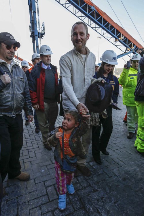 Sean Gastonguay holds the hand of his 3-year-old daughter Ardith as they arrive in the port city of San Antonio, Chile, Friday, Aug. 9, 2013. Gastonguay, along with his father, wife and their two children were lost at sea for weeks in an ill-fated attempt to leave the U.S. over what they consider government interference in religion. But just weeks into their journey the Gastonguays hit a series of storms that damaged their small boat, leaving them adrift for weeks. They were eventually picked up by a Venezuelan fishing vessel, transferred to a Japanese cargo ship and taken to Chile where they are resting in a hotel in San Antonio. (AP Photo/Las Ultimas Noticias)