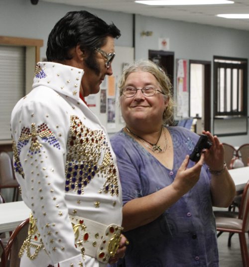 Gil "Gilvis" White of Regina, Sask. stops to take a look at a photo snapped by a fan moments before he's destined to grace the stage at the Gimli Recreation Centre at the Gimli Elvis Festival on Saturday, August 10, 2013. (JESSICA BURTNICK/WINNIPEG FREE PRESS)