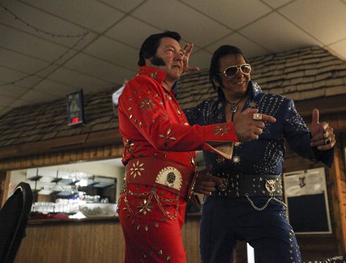 Gil White (left) and Gerry Barrett pose for one last shot in their nearly matching Elvi jumpsuits in the Elvi rest area on the second floor of the Gimli Recreation Centre at The Gimli Elvis Festival on Saturday, August 10, 2013. (JESSICA BURTNICK/WINNIPEG FREE PRESS)