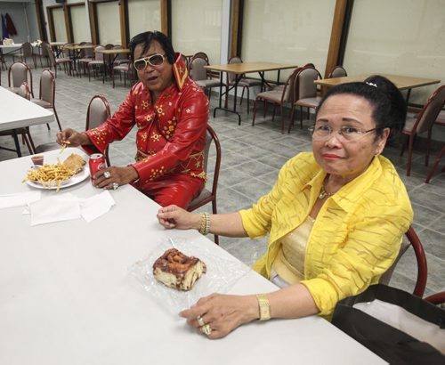 One must eat like a king to sing like one. Jon Baunsit of Winnipeg (left) chows down of fries and a coke at the Gimli Elvis Festival on Saturday, August 10, 2013. His wife, Lilia, opted for a cinnamon bun from the canteen instead. (JESSICA BURTNICK/WINNIPEG FREE PRESS)