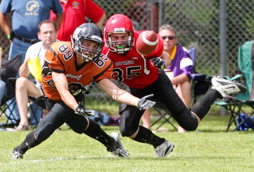 Brandon Sun 10082013 Jason Black #35 of the St. Vital Vikings tries to keep Jesse Smith #89 of the Westman Wolverines from making a catch during Manitoba Major Football League action at Vincent Massey High School on Saturday afternoon. (Tim Smith/Brandon Sun)