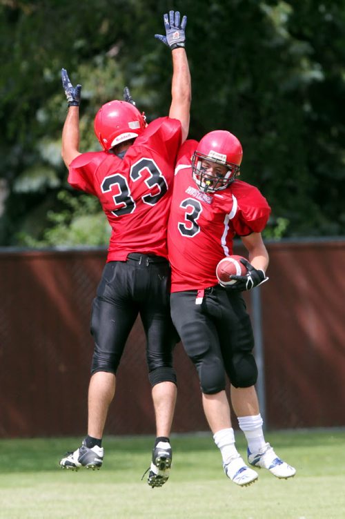Brandon Sun 10082013 Michael DiBiase #3 of the St. Vital Vikings celebrates a touchdown with teammate Zacary Smook #33 during the Manitoba Major Football League Action against the Westman Wolverines at Vincent Massey High School on Saturday afternoon. (Tim Smith/Brandon Sun)