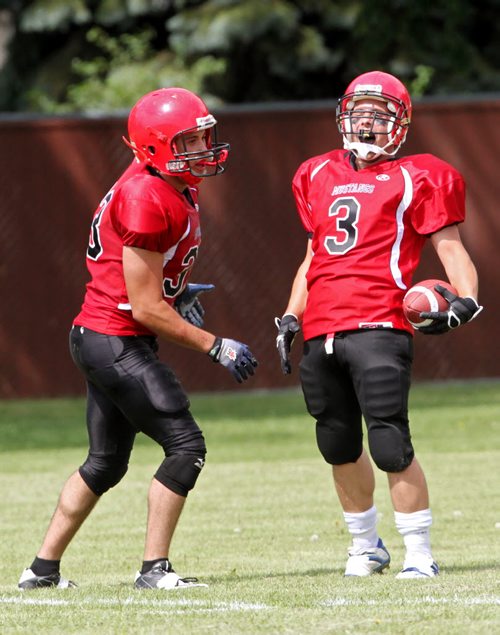 Brandon Sun 10082013 Michael DiBiase #3 of the St. Vital Vikings celebrates a touchdown with teammate Zacary Smook #33 during the Manitoba Major Football League Action against the Westman Wolverines at Vincent Massey High School on Saturday afternoon. (Tim Smith/Brandon Sun)