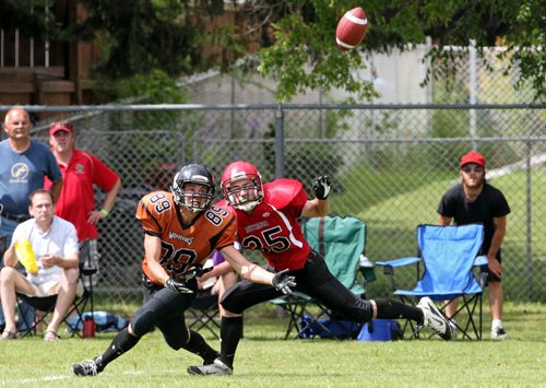 Brandon Sun 10082013 Jason Black #35 of the St. Vital Vikings tries to keep Jesse Smith #89 of the Westman Wolverines from making a catch during Manitoba Major Football League action at Vincent Massey High School on Saturday afternoon. (Tim Smith/Brandon Sun)