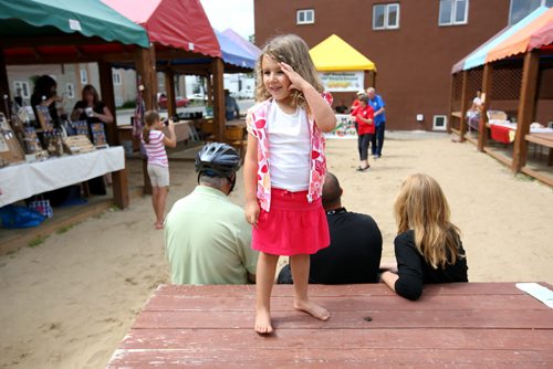 Brandon Sun 10082013 Four-year-old Serine Salhi (Warkentin) looks for friends from on top of a picnic table at the Global Market on Rosser Ave. on Saturday.  (Tim Smith/Brandon Sun)