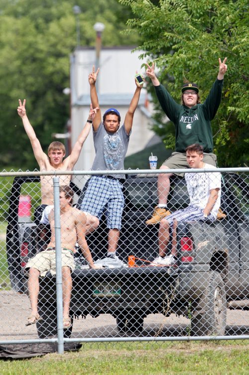 Brandon Sun 10082013 Football fans watch the action between the Westman Wolverines and the St. Vital Vikings from the back of a pickup truck at Vincent Massey High School on Saturday. (Tim Smith/Brandon Sun)