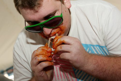 Brandon Sun 10082013 Lane Quigley works his way through as many hot wings as he can in seven minutes during the wing eating competition at the 1st Annual Margarita-Ville Beach Party at The Dock on Princess on Saturday afternoon. (Tim Smith/Brandon Sun)